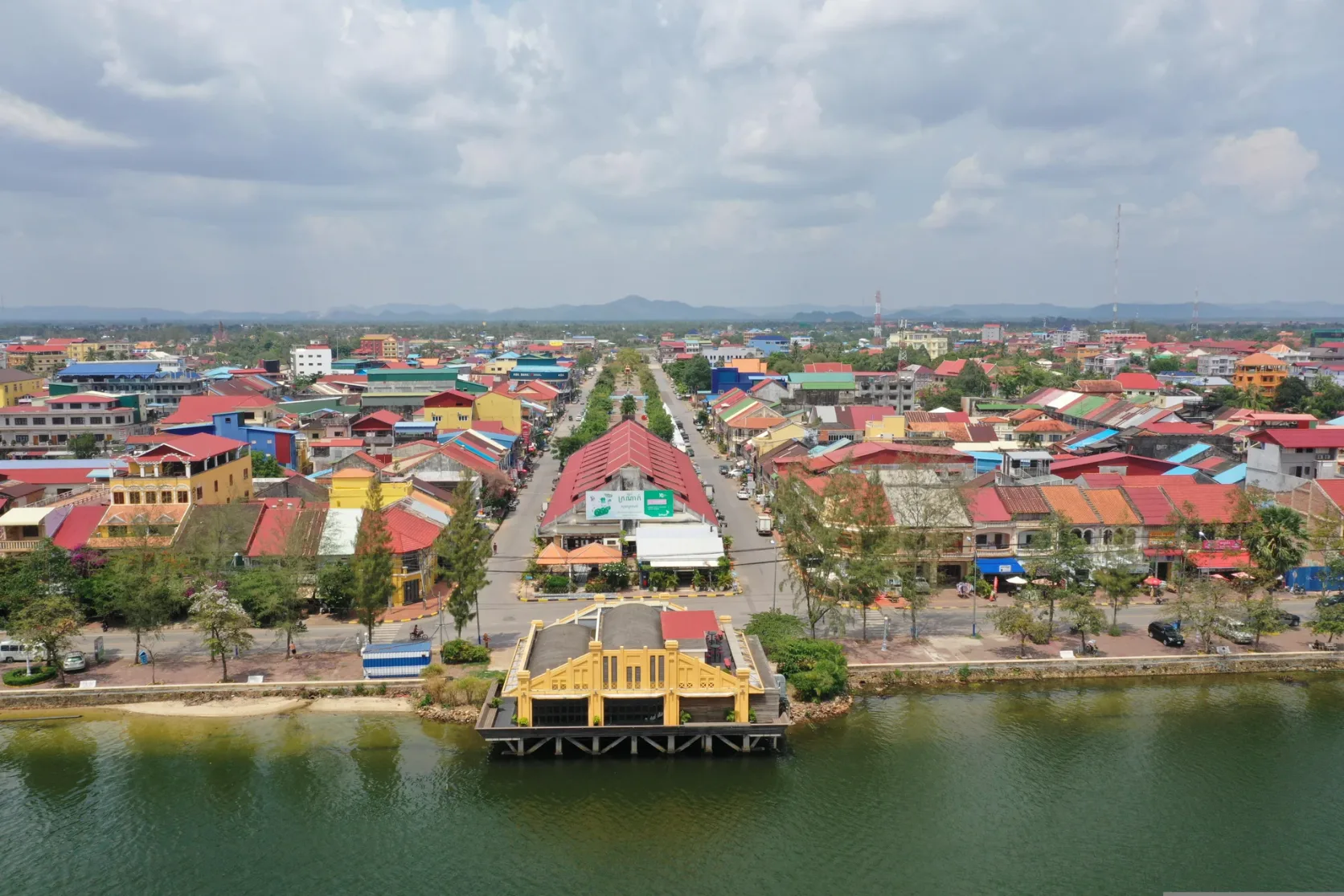Kampot's riverfront buildings and streets beside the river.