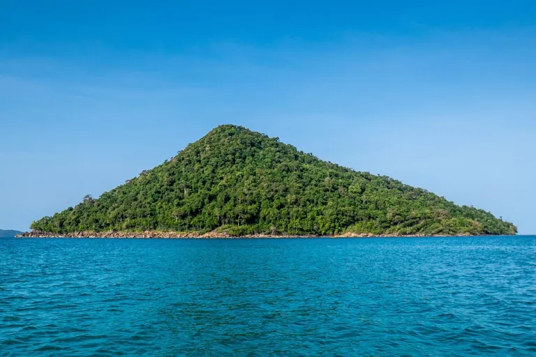 A forested island surrounded by blue sea off Koh Rong Samloem.