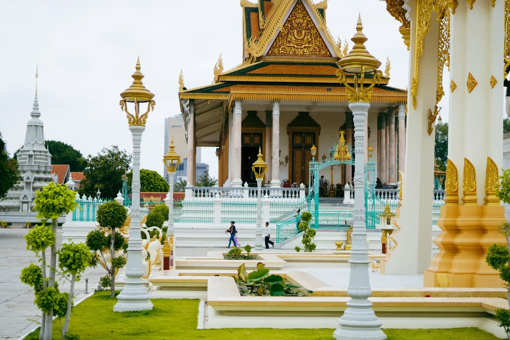 Ornate golden roofs and courtyard at Phnom Penh's Royal Palace.